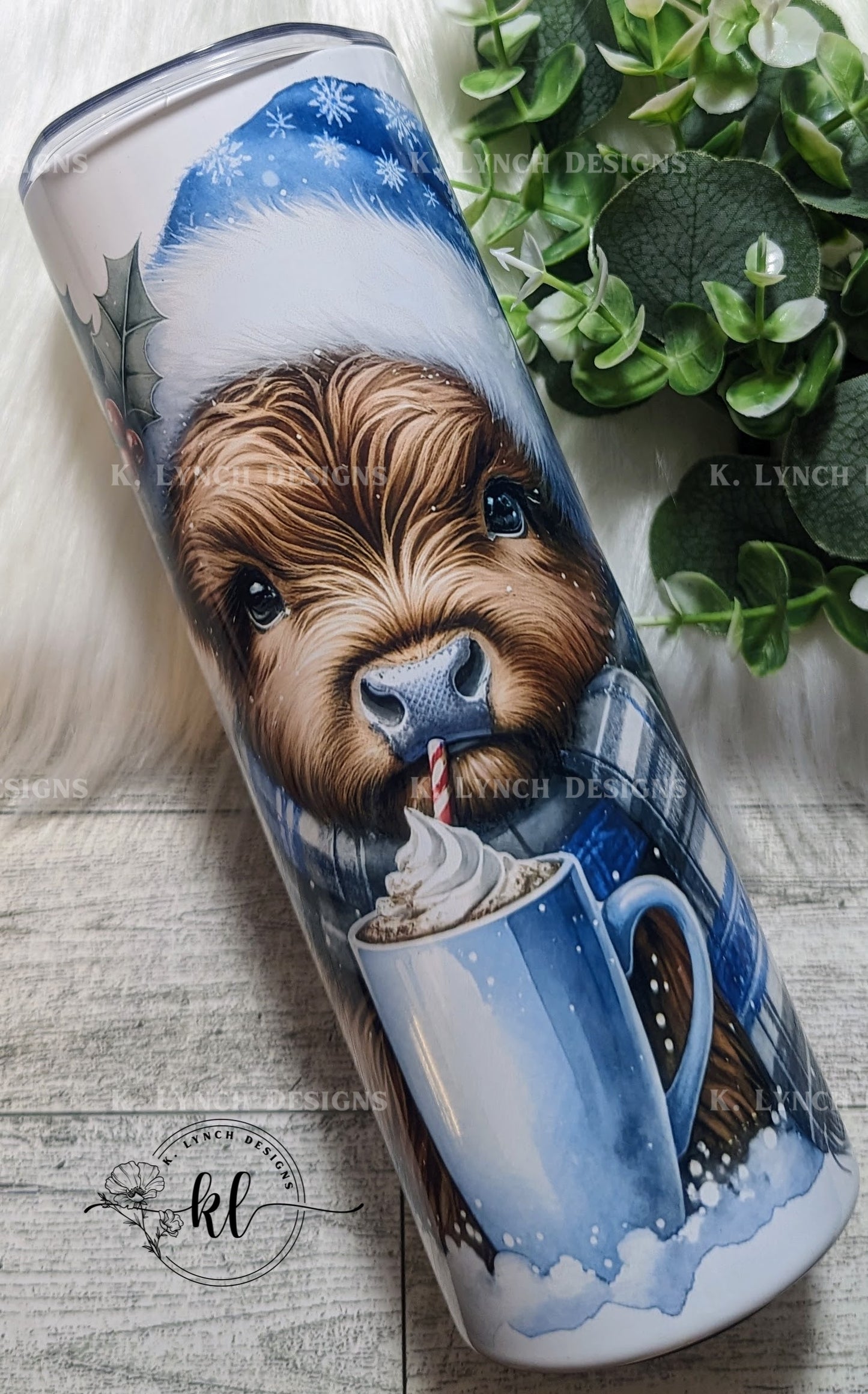 20 oz. Baby Highland Cow w/Blue Snowflake Hat Sipping Hot Chocolate